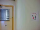 Een blik op een deur en aan de muur hangt een “Slaapkamer” bordje